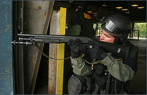 SWAT team member, rehearsing a standoff.